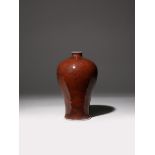 A CHINESE COPPER-RED GLAZED MEIPING 18TH CENTURY The ovoid body tapering and then gently flaring