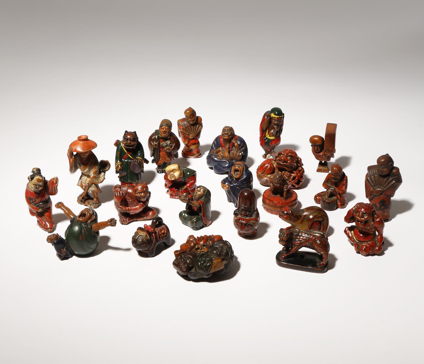 A COLLECTION OF TWENTY-THREE WOOD AND LACQUER NETSUKE EDO PERIOD AND LATER, 18TH CENTURY AND LATER