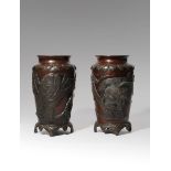 A PAIR OF JAPANESE BRONZE VASES MEIJI PERIOD, 19TH CENTURY The bodies cast with a continuous scene