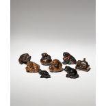 EIGHT JAPANESE WOOD NETSUKE OF DOGS MEIJI PERIOD, 19TH CENTURY Depicted in a variety of positions,