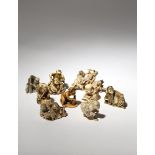 NINE JAPANESE IVORY NETSUKE MEIJI PERIOD, 19TH CENTURY Depicting figures engaged in a variety of