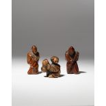 THREE JAPANESE WOOD NETSUKE OF FIGURES EDO AND MEIJI PERIOD, 18TH AND 19TH CENTURY One carved as a