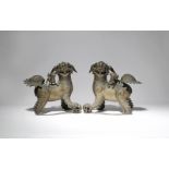 A PAIR OF LARGE CHINESE BRONZE MODELS OF LION DOGS QING DYNASTY Each beast depicted with one paw
