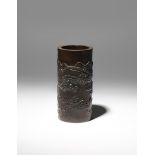 A CHINESE BAMBOO 'LANDSCAPE' BRUSHPOT, BITONG QING DYNASTY The narrow cylindrical body carved in