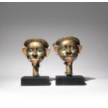 A PAIR OF INDIAN BRASS HEADS OF SHIVA EARLY 19TH CENTURY Each formed as the deity with his mouth