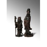 TWO LARGE CHINESE WOOD FIGURES 19TH/20TH CENTURY The larger figure carved as Guanyin standing upon a