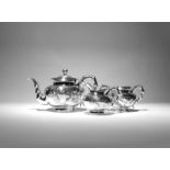 λ A CHINESE SILVER THREE-PIECE TEA SET 19TH CENTURY Comprising: a teapot with a hinged cover, a