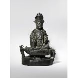 A LARGE CHINESE BRONZE FIGURE OF GUANYIN 17TH CENTURY The deity depicted seated in rajalilasana upon