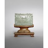 A CHINESE PALE CELADON JADE PLAQUE 19TH CENTURY Formed as a lock, carved in low relief with a