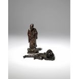 TWO CHINESE WOOD FIGURES QING DYNASTY One depicting a scholar holding a fan whilst his other hand