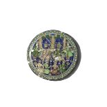 A LARGE QAJAR POLYCHROME MOULDED CIRCULAR TILE 19TH CENTURY Painted in green, blue, aubergine, black