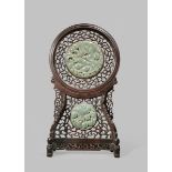 A CHINESE CELADON JADE TABLE SCREEN LATE QING DYNASTY With two grey-green jade circular panels,