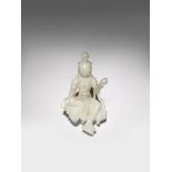 A CHINESE WHITE JADE CARVING OF AVALOKITESHVARA 20TH CENTURY The bodhisattva depicted seated in