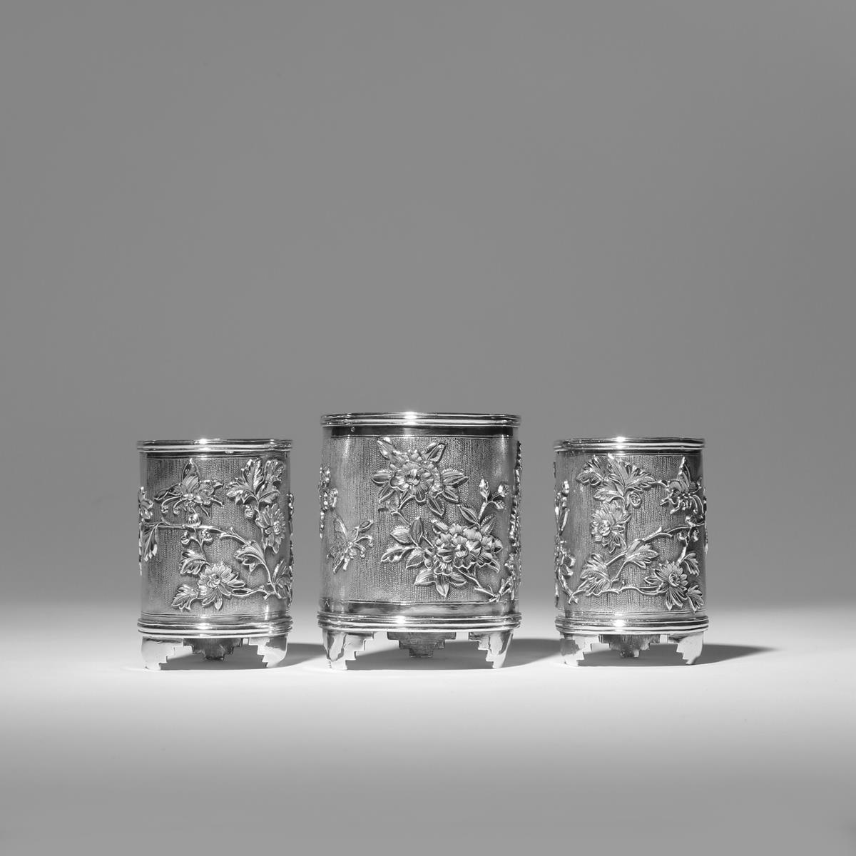 THREE CHINESE SILVER BRUSHPOTS, BITONG 2ND HALF 19TH CENTURY Decorated in relief with butterflies in