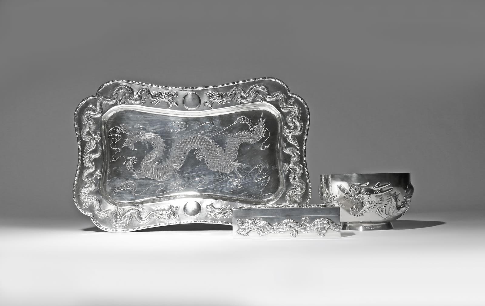 THREE CHINESE SILVER ITEMS DECORATED WITH DRAGONS 2ND HALF 19TH CENTURY Comprising: a tray with