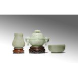THREE CHINESE PALE CELADON JADE ITEMS QING DYNASTY Comprising: a small vase carved with archaistic