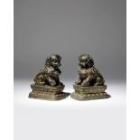 A PAIR OF CHINESE BRONZE MODELS OF LION DOGS QING DYNASTY Each cast with bulging eyes and fierce