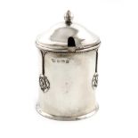 By A. E. Jones, an Arts and Crafts silver preserve pot and cover, Birmingham 1919, cylindrical form,
