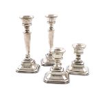 A pair of silver candlesticks and a matching pair of dwarf silver candlesticks, by L J Millington,