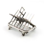 A Victorian silver seven-bar toast rack, by George Fox, London 1865, modelled as saltire bars,