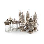 A mixed lot of silver condiments, comprising: four George III pepper pots, baluster form, flame,