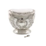 A Victorian silver tea caddy, by William Comyns, London 1888, oval form, embossed ribbon-tied
