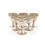 A set of six Edwardian silver egg cups, by the Pairpoint Brothers, London 1905, tapering circular