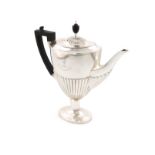 A silver coffee pot, by William Hutton and Sons, London 1910, tapering oval form, part-fluted