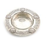 By Liberty and Co., an Arts and Crafts silver butter dish, Birmingham 1928, circular form, applied