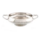 By A. E. Jones, an Arts & Crafts silver two-handled bowl, Birmingham 1928, circular form, spot-