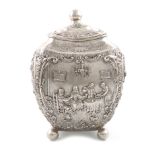 A German silver tea caddy, circa 1895, rounded tapering rectangular form, embossed with figural