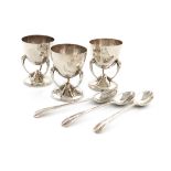 By Lawson & Co, a set of three Edwardian Scottish Art Nouveau silver egg cups and spoons, Glasgow