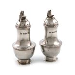 By Leslie Durbin, a pair of Arts and Crafts silver casters, London 1953, circular bellied form, with