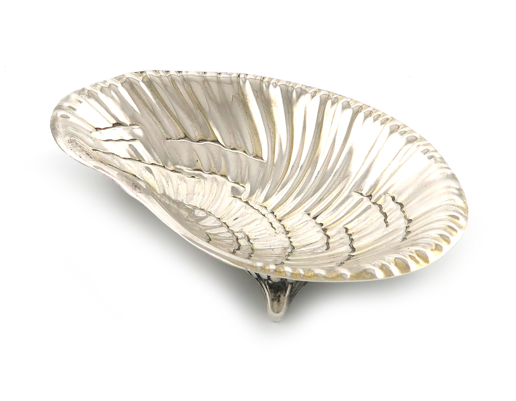 By Tiffany and Co. an American silver dish, Edward Moore period, modelled as an oyster, on three