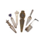 A collection of six page markers, comprising silver item, an Asprey sprung-action page marker,