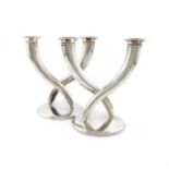 By Christofle, a pair of French electroplated two-light candelabra, tapering scroll arms, on
