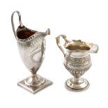 A George III silver cream jug, maker's mark worn, London 1787, helmet form, scroll handle, punch