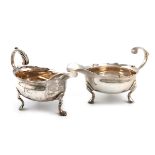 A George II silver cream boat, by Edward Wood, London 1742, oval form, wavy-edge border, leaf capped