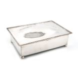 By A. E. Jones, an Arts and Crafts silver cigarette box, Birmingham 1926, rectangular form, spot-