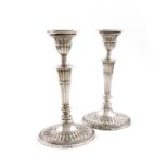 A pair of silver candlesticks, by The Barker Brothers, Sheffield 1922, tapering fluted oval form,