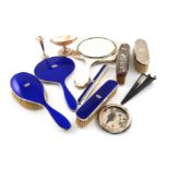 A mixed lot of silver dressing table items, including a four-piece silver and dark blue enamel