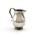 A modern silver sparrow-beak cream jug, by R. Comyns, London 1971, plain baluster form, scroll