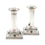 By Liberty and Co, a pair of Edwardian silver and enamel candlesticks, Birmingham 1907, faceted