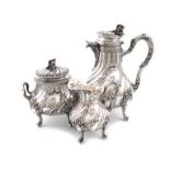 λA matched three-piece French silver hot chocolate set, the coffee pot with maker's mark of LD in