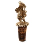 A Victorian silver-gilt bottle stopper, by Robert Hennell, London 1858, modelled as a standing dwarf