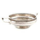 By A. E. Jones, an Arts and Crafts silver two-handled bowl, Chester 1922, circular form, scroll