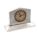 A silver clock, by A L Davenport Ltd., Birmingham 1929, rectangular arched form, engine-turned