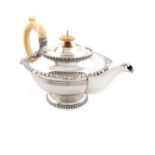 λA silver teapot, by Walker and Hall, Sheffield 1932, circular form, heavy gadroon and shell border,