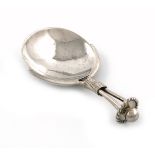 By A. E. Jones, an Arts and Crafts silver caddy spoon, Birmingham 1919, spot-hammered circular bowl,