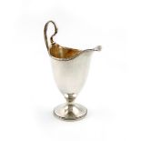 A George III silver cream jug, by Robert Hennell, London 1802, helmet form, beaded borders and